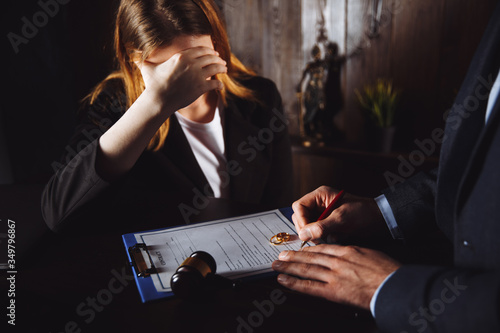 Fotografi Divorce process. Man and woman sign documents because of broke up