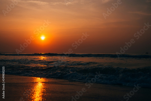 waves at sea against the orange sunrise