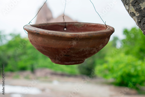 water in clay pot for birds in hot summer