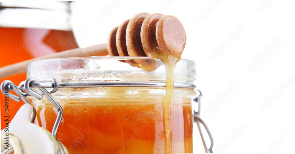 Composition with stick and open jar of honey Composition with stick and open jar of honey
