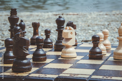 Playing chess on a lakeside in Slovakia, Ivanka pri Dunaji. Chessboard on a stones. photo