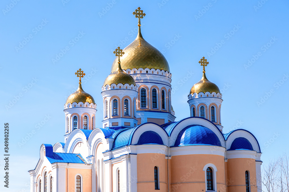 Golden domes of orthodox cathedral against the blue sky background