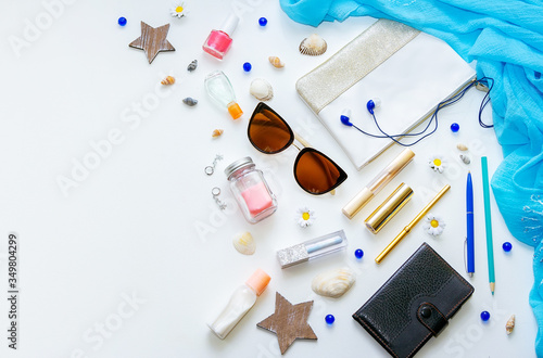 Outfit of young woman or modern teenager girl on white background – cosmetic and lifestyle accessories. Flat lay objects. 