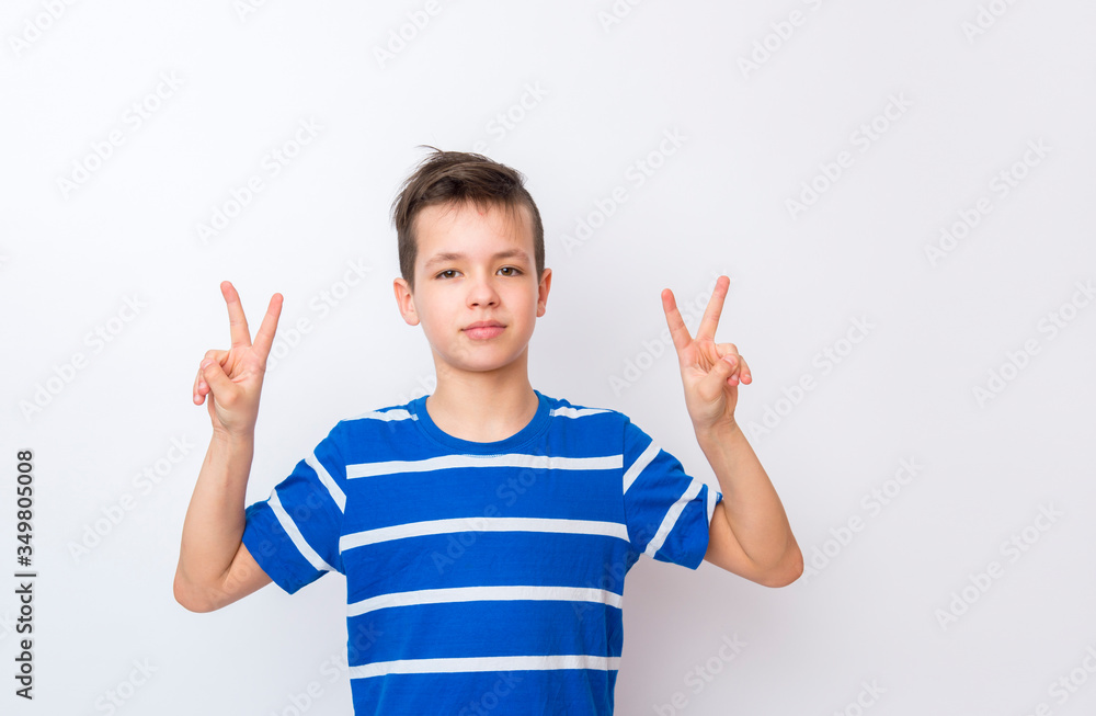 Happy boy on a white background expresses emotions through gestures Happy boy on a white background expresses emotions through gestures