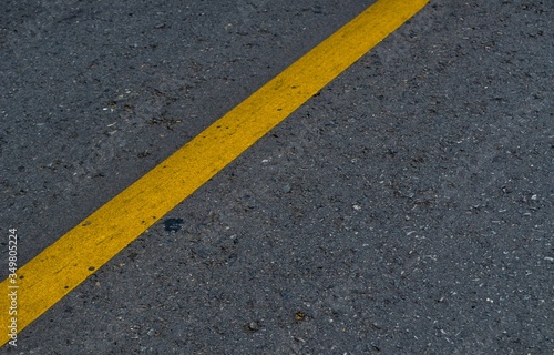  Yellow line on old asphalt road. © Worawat