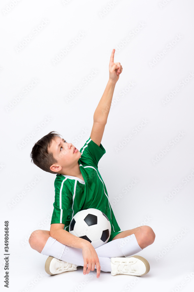Kid play with soccer ball over white background. Kid activities.Training game concept.