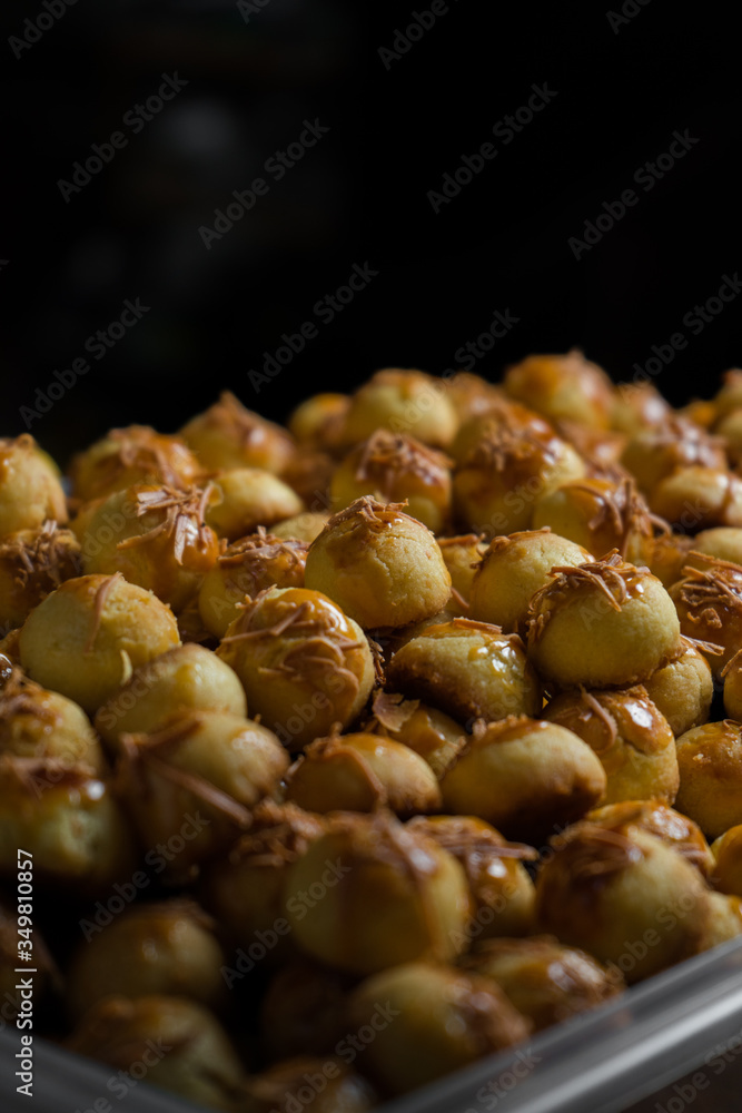 Nastar, an eid cookies with dark background and directional studio light Nastar, an eid cookies with dark background and directional studio light