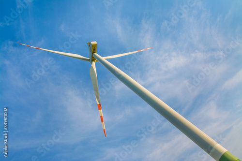 Wind farm, green energy. Windmill on a blue background. © VinyLove Foto