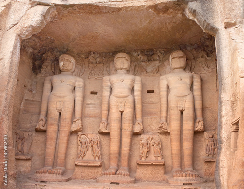 Ancient Jain statues carved out of rock in Gwalior, Madhya Pradesh, India. Siddhachal Jain Temple Caves were built in 7th to 15th century.  photo