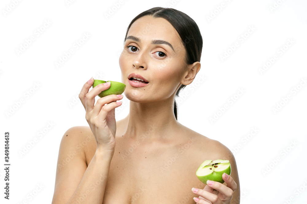 close-up portrait of a girl with clear skin holding a apple to her face, isolated on a white background close-up portrait of a girl with clear skin holding a apple to her face, isolated on a white background