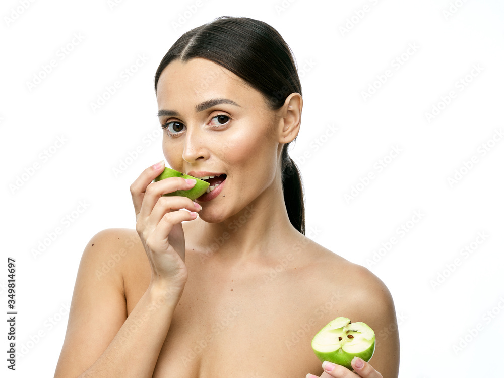 close-up portrait of a girl with clear skin holding a apple to her face, isolated on a white background close-up portrait of a girl with clear skin holding a apple to her face, isolated on a white background