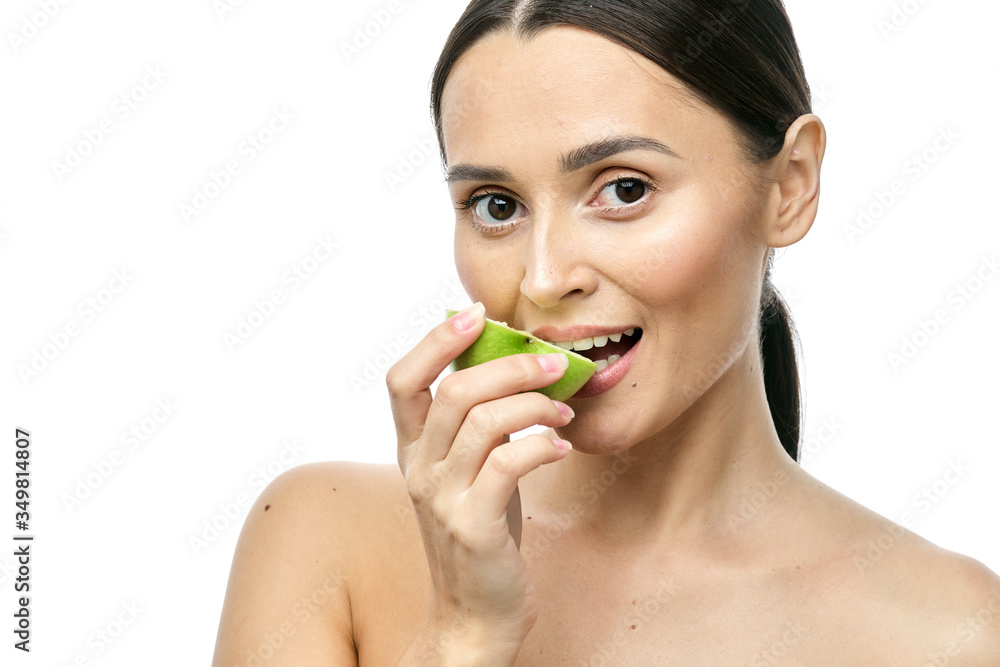close-up portrait of a girl with clear skin holding a apple to her face, isolated on a white background close-up portrait of a girl with clear skin holding a apple to her face, isolated on a white background