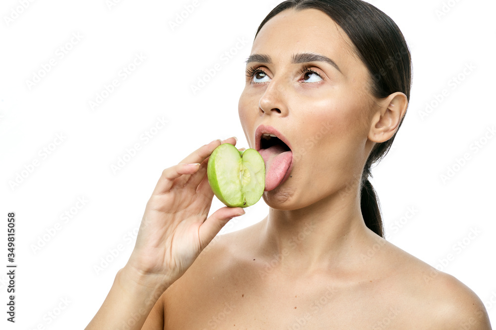 close-up portrait of a girl with clear skin holding a apple to her face, isolated on a white background close-up portrait of a girl with clear skin holding a apple to her face, isolated on a white background