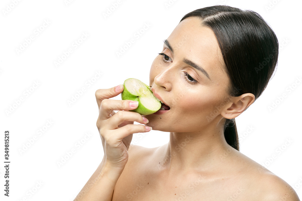 close-up portrait of a girl with clear skin holding a apple to her face, isolated on a white background close-up portrait of a girl with clear skin holding a apple to her face, isolated on a white background