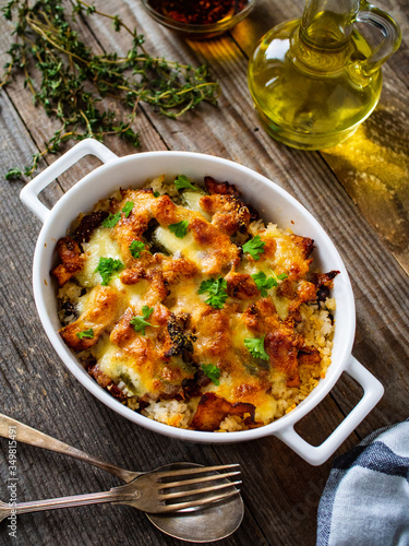 Rice casserole with barbecue chicken breast, cheese and vegetables 