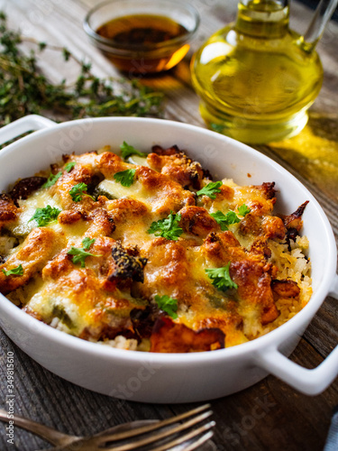 Rice casserole with barbecue chicken breast, cheese and vegetables 