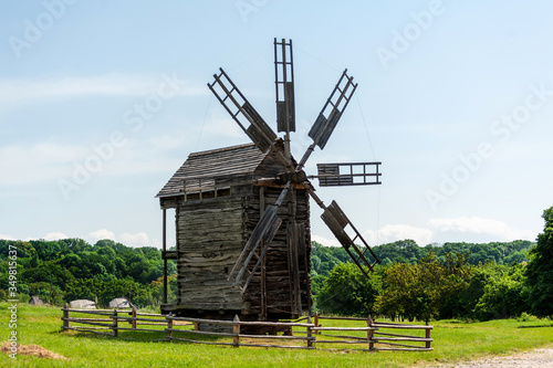 wooden old mill on a background of blue sky