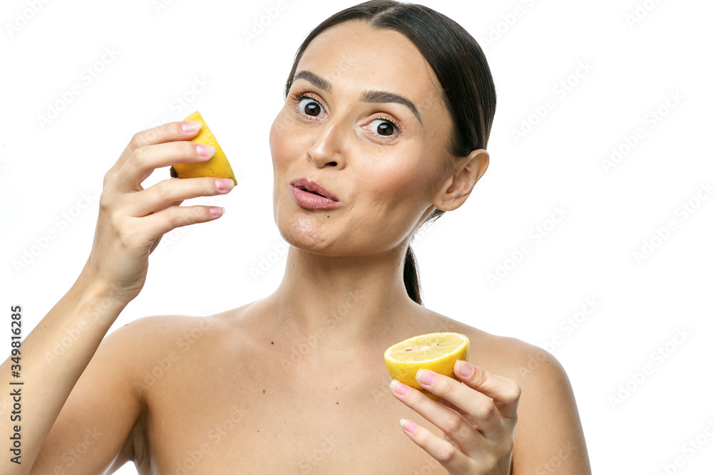 close-up portrait of a girl with clear skin holding a lemon fruit to her face, isolated on a white background close-up portrait of a girl with clear skin holding a lemon fruit to her face, isolated on a white background