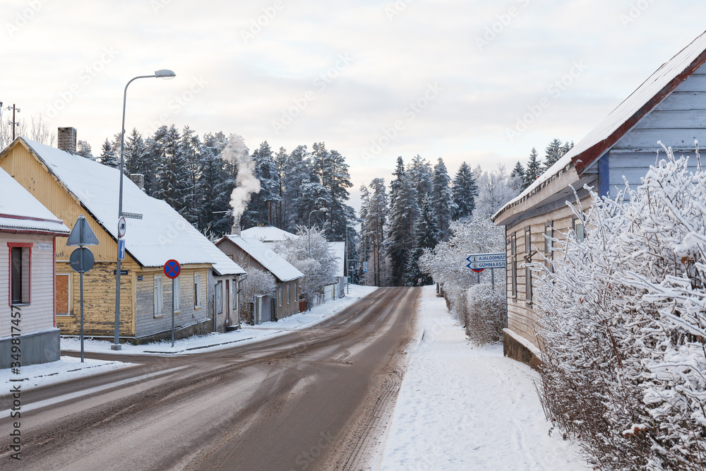 Wooden houses of small town at snowy winter. Rural Estonia.