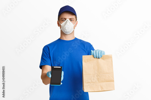 Courier in blue uniform holding package and offers to pay with terminal