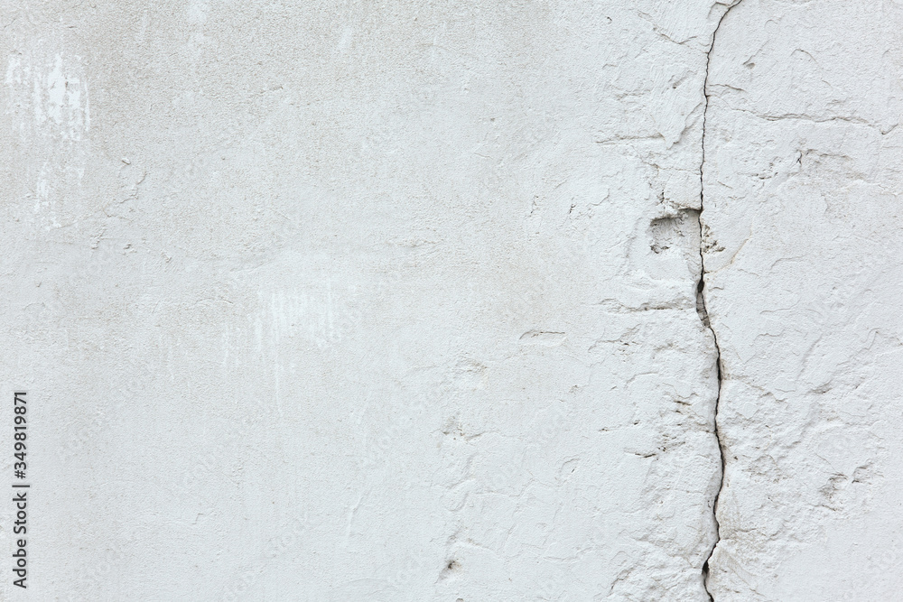 Texture and background. White old concrete wall with a crack Texture and background. White old concrete wall with a crack