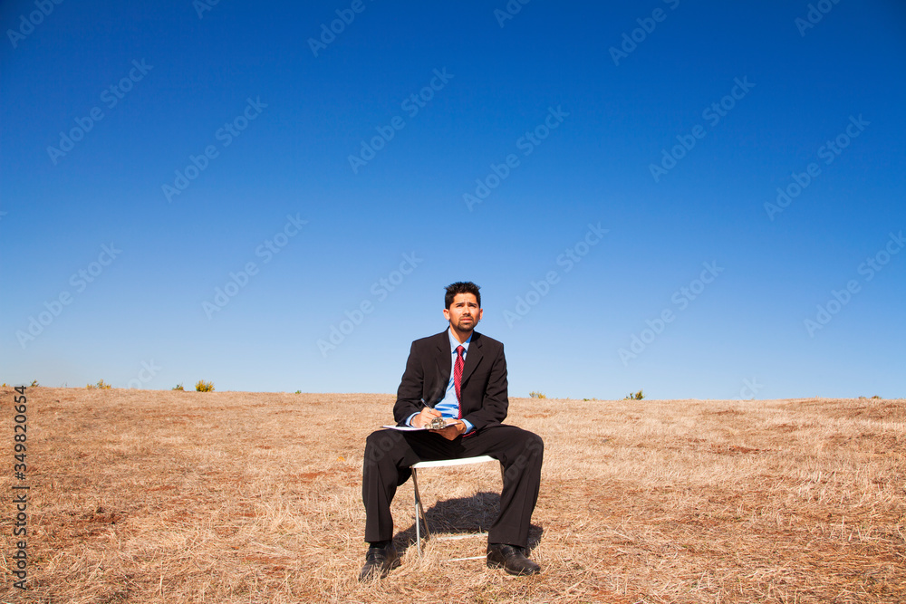 Powerful businessman holding a notepad Powerful businessman holding a notepad