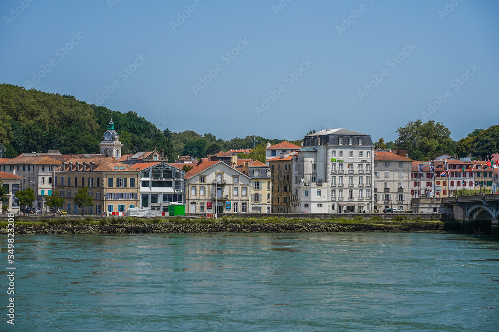 The city of Bayonne in France with buildings in the Nive River