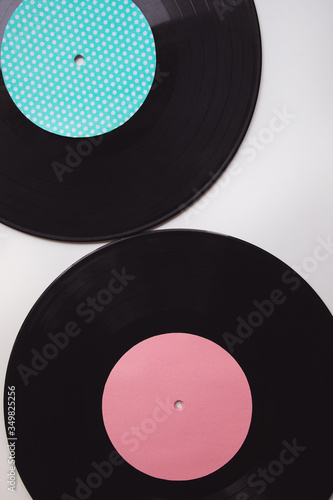 Black vinyl arranged on a white background seen from above