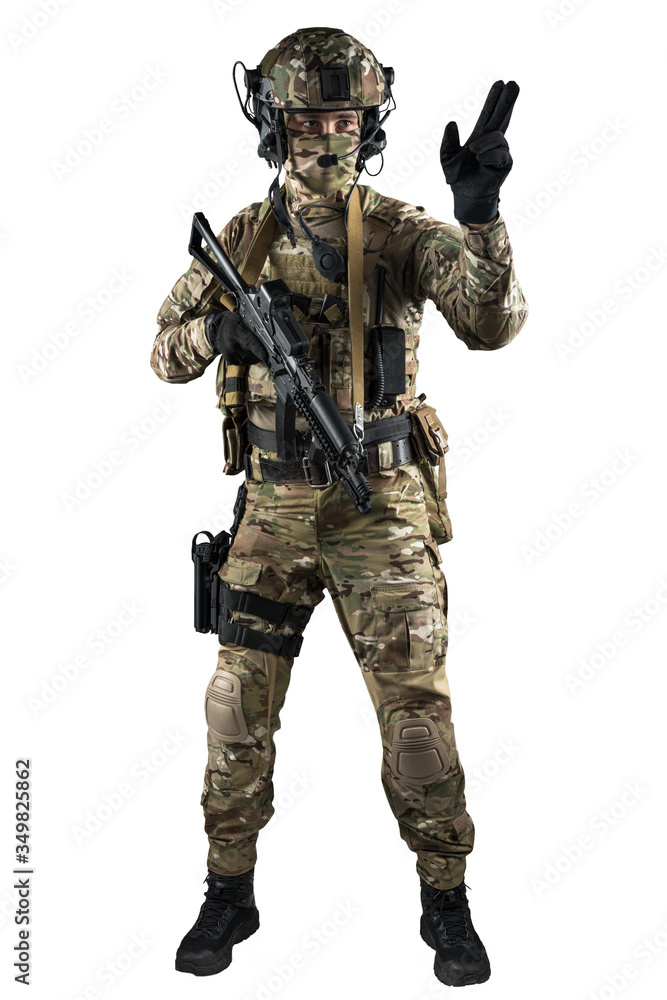 Soldier holding assault rifle. Uniform conforms to special services of the Russian Federation. Shot in studio. Isolated with clipping path on white background