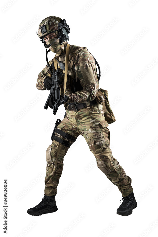 Soldier holding assault rifle. Uniform conforms to special services of the Russian Federation. Shot in studio. Isolated with clipping path on white background Soldier holding assault rifle. Uniform conforms to special services of the Russian Federation. Shot in studio. Isolated with clipping path on white background