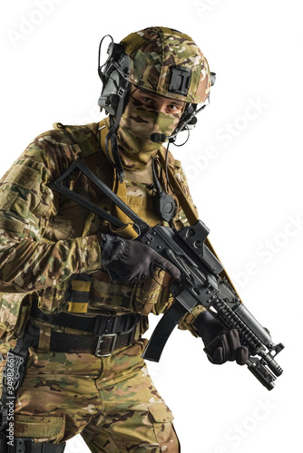 Soldier holding assault rifle. Uniform conforms to special services of the Russian Federation. Shot in studio. Isolated with clipping path on white background