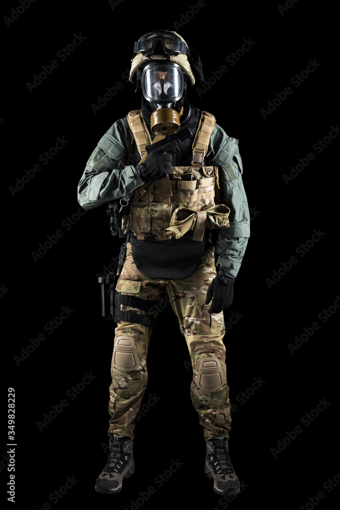 Soldier holding assault rifle. Uniform conforms to special services of the Russian Federation. Shot in studio. Isolated with clipping path on black background Soldier holding assault rifle. Uniform conforms to special services of the Russian Federation. Shot in studio. Isolated with clipping path on black background