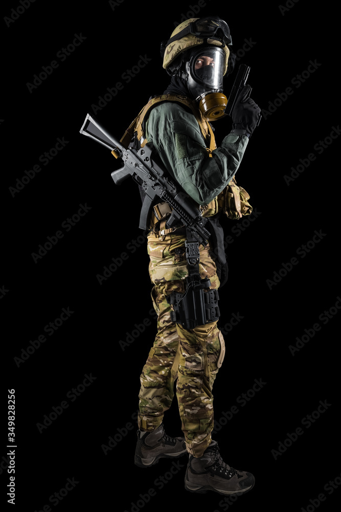 Soldier holding assault rifle. Uniform conforms to special services of the Russian Federation. Shot in studio. Isolated with clipping path on black background Soldier holding assault rifle. Uniform conforms to special services of the Russian Federation. Shot in studio. Isolated with clipping path on black background
