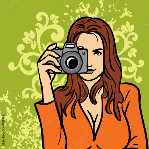 Close up portrait of a smiling beautiful girl in a dress takes a picture with a camera in her hand on a floral background.