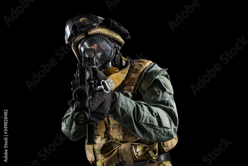 Soldier holding assault rifle. Uniform conforms to special services of the Russian Federation. Shot in studio. Isolated with clipping path on black background