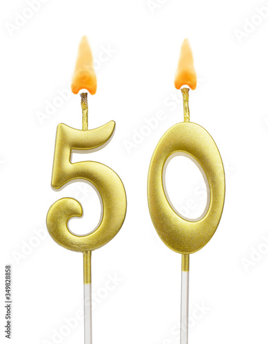 Burning golden birthday candles isolated on white background, number 50