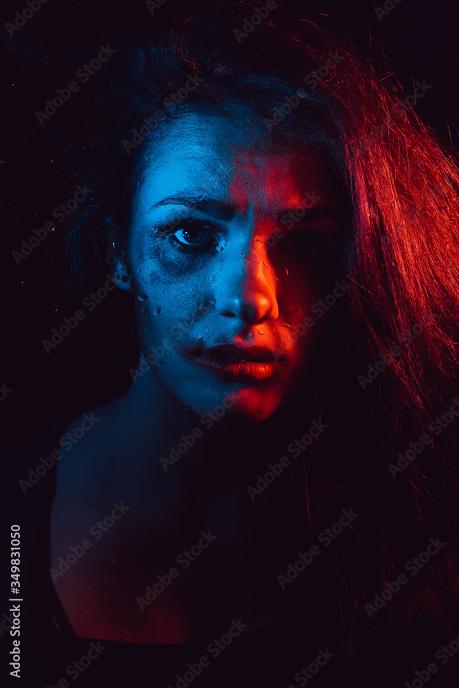 Sensual portrait of sad crying girl behind glass with raindrops Sensual portrait of sad crying girl behind glass with raindrops