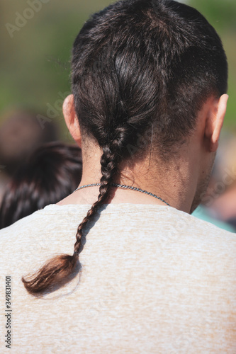фотографія A pigtail in the hair on the head