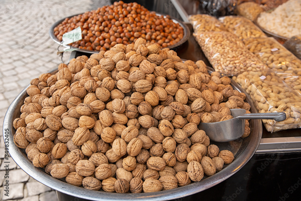 Nuts on a large platter on sale. Market for Eastern sweets. variety of nut varieties on the market Nuts on a large platter on sale. Market for Eastern sweets. variety of nut varieties on the market