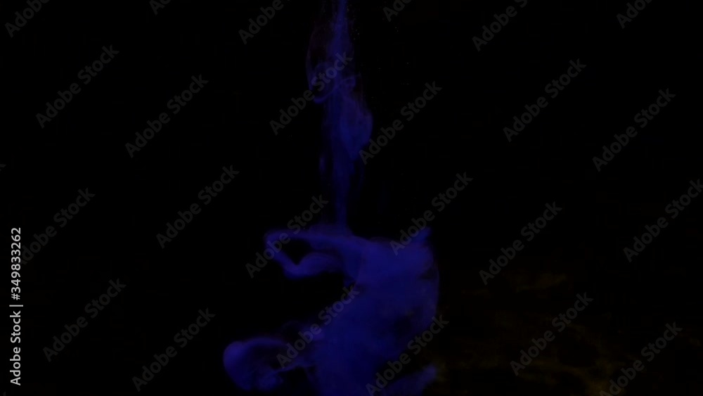 Dark blue ink mixing in water, swirling softly underwater on black background with copy space. Colored acrylic cloud of paint isolated. Colorful abstract smoke explosion animation. Slowmotion Dark blue ink mixing in water, swirling softly underwater on black background with copy space. Colored acrylic cloud of paint isolated. Colorful abstract smoke explosion animation. Slowmotion