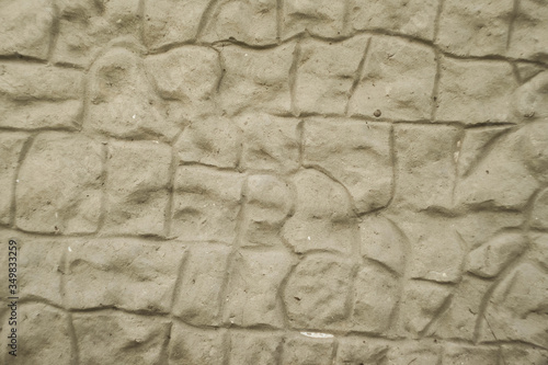 Stone wall texture. Asymmetric bricks. Concreted wall background 
