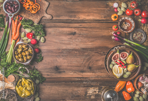 Wallpaper Mural Healthy food and snack background. Bowls with tasty ingredients of Mediterranean cuisine: various vegetables, olives, pickled pepperoni and figs on wooden rustic table. Top view. Frame. Vegan food Torontodigital.ca