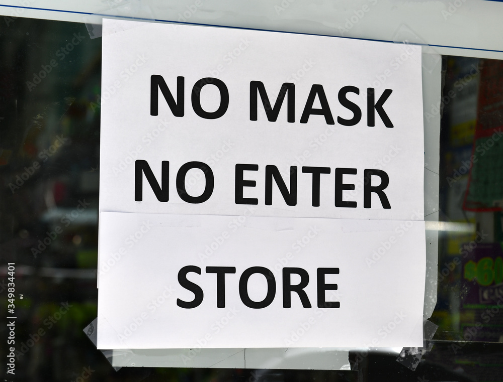 Warning sign to customers that a face mask is required to enter retail store due to COVID-19 coronavirus pandemic Warning sign to customers that a face mask is required to enter retail store due to COVID-19 coronavirus pandemic