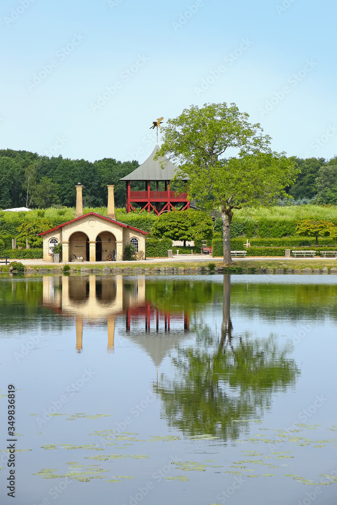 Fototapeta premium Traditional buildings on the edge of a beautiful lake with reflections in the water, located near Kvaerndrup, in the south of the island of Funen, Denmark.