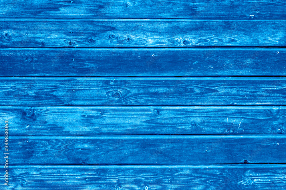 wooden boards background. aged burned black and blue wooden planks. toned classic blue color trend 2020 year wooden boards background. aged burned black and blue wooden planks. toned classic blue color trend 2020 year