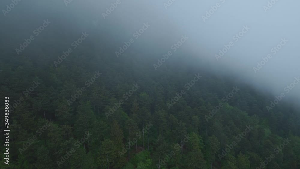 Clouds passing by mountain peaks on rainy day Clouds passing by mountain peaks on rainy day