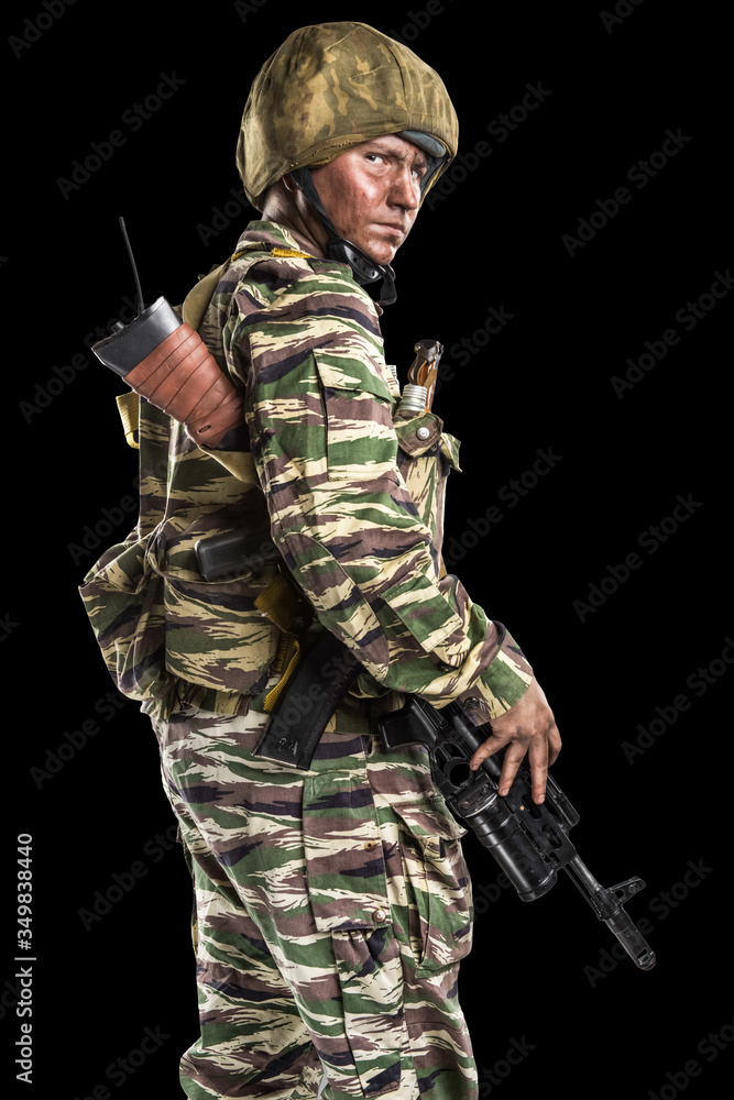 Male in uniform conforms to Russian army special forces (OMON) in War in Chechnya. Isolated on black backgroundx