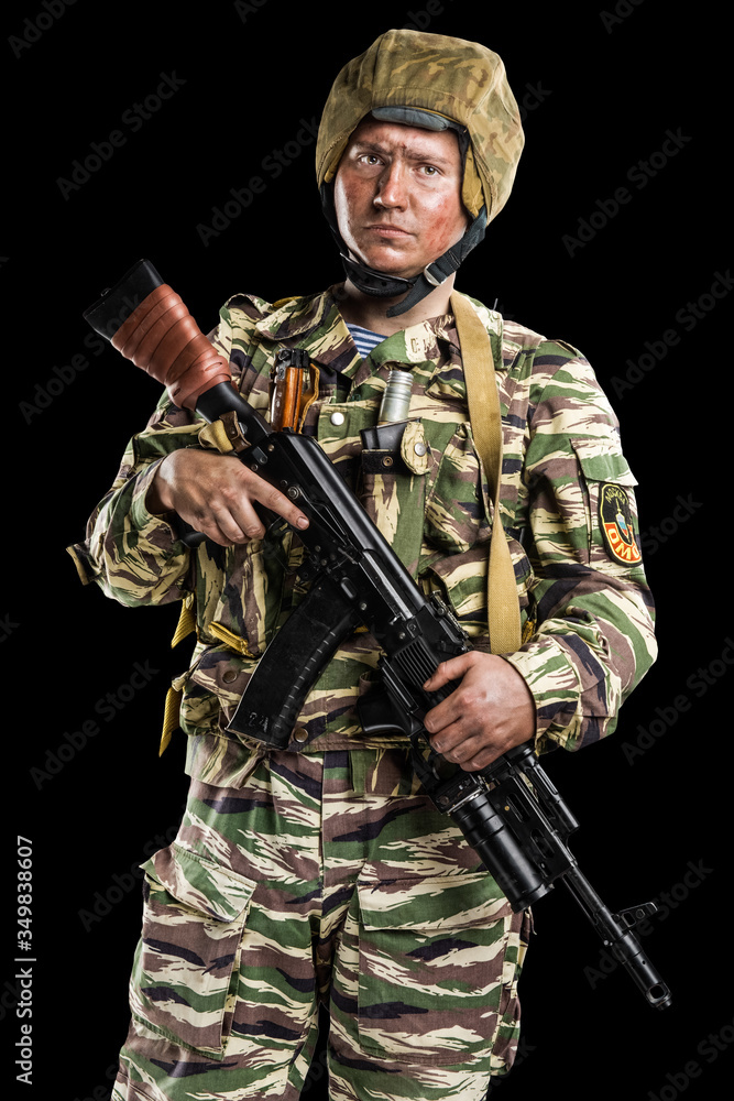 Male in uniform conforms to Russian army special forces (OMON) in War in Chechnya. Isolated on black backgroundx