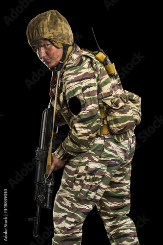 Male in uniform conforms to Russian army special forces (OMON) in War in Chechnya. Isolated on black backgroundx photo