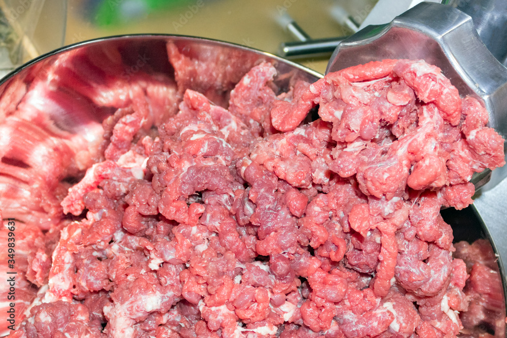 minced meat chopped in a meat grinder. Suitable for background and space for advertising minced meat chopped in a meat grinder. Suitable for background and space for advertising